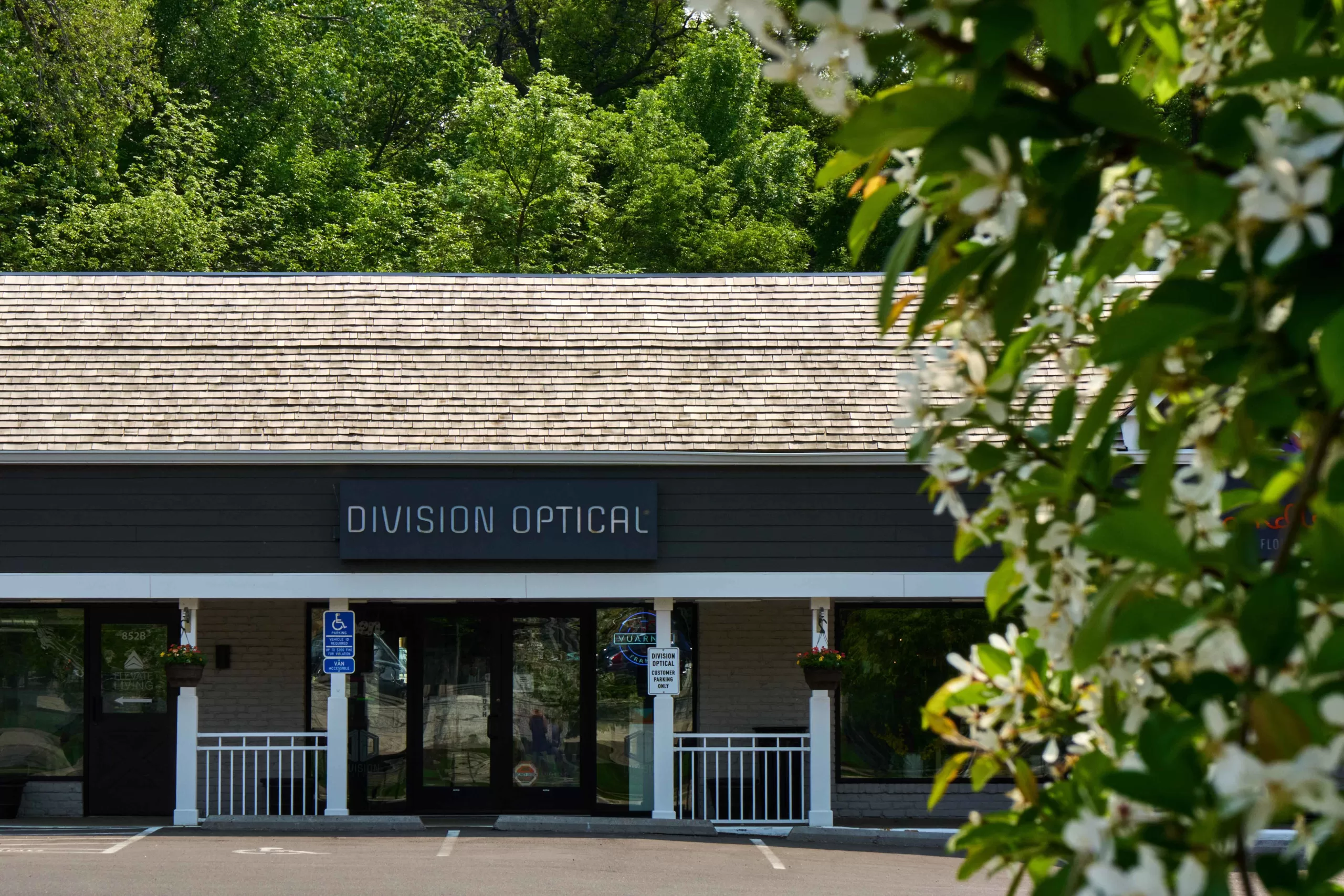 division optical store front with trees2560